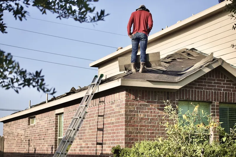 Professional roofer working on a residential roof in Barstow